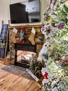 a christmas tree in a living room with a fireplace at Mountain Views, Game Room, Firepit Near Wineries in Cleveland