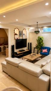 a living room with a couch and a table at Villa Bleu Horizon in El Haouach