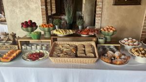 a table with many different types of bread and pastries at Borgo di Santa Barbara in Santa Domenica +256 photos