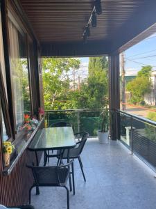 a patio with a table and chairs on a balcony at Appartaments Anna Kostava in Kobuleti