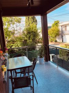 a patio with a table and chairs on a balcony at Appartaments Anna Kostava in Kobuleti