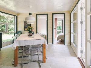 a dining room with a table and chairs at 4 star holiday home in Væggerløse in Bøtø By