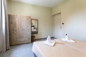 a bedroom with two beds with towels on them at Nikos & Vassilis apartments Kefalonia in Vlachata +211 photos