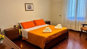 a bedroom with a bed with two towels on it at Tuscan Charm Spacious Florence Home in Campi Bisenzio