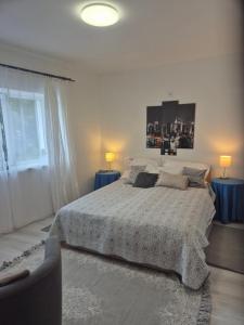 a bedroom with a large bed with two blue tables at La Casa Vendégház in Bogács