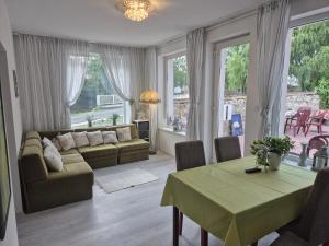 a living room with a couch and a table at La Casa Vendégház in Bogács