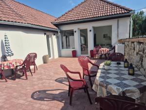 a patio with a table and chairs and a table and chairsktop at La Casa Vendégház in Bogács +5 photos