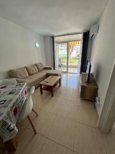 a living room with a couch and a table at Cozy Apartment with Pool at 5 Min to Beach in Salou +11 photos