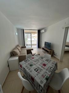 a living room with a table and a couch at Cozy Apartment with Pool at 5 Min to Beach in Salou