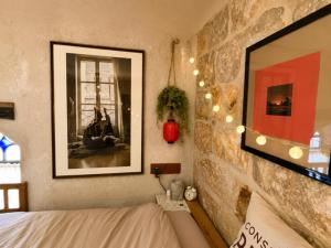 a bedroom with a bed and a picture on the wall at Narkis - A Boutique Stay in the Heart of Jerusalem in Jerusalem