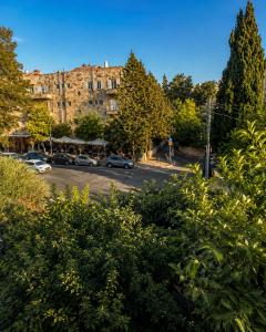a street with cars parked in a parking lot at Narkis - A Boutique Stay in the Heart of Jerusalem in Jerusalem
