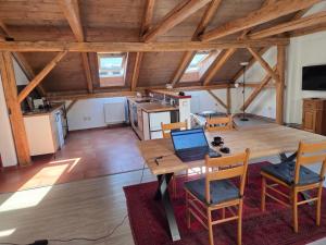 a room with a wooden table with a laptop on it at Apartmán U lípy in Semily