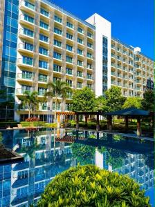 a hotel with a pool in front of a building at Yssabelle's Homestay in Sampong