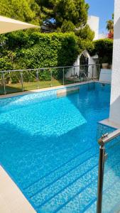 a large swimming pool with blue water at Villa Bleu Horizon in El Haouach
