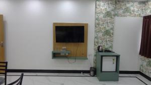 a room with a flat screen tv on a wall at Hotel Rudra Heritage in Jasidih
