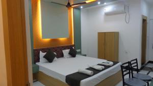 a bedroom with a bed with towels on it at Hotel Rudra Heritage in Jasidih