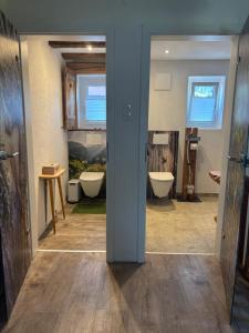 a bathroom with two sinks and two toilets at Ferienhaus Gruber in Aich