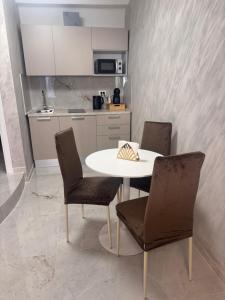 a kitchen with a table and two chairs and a kitchen at Romantic Suite Genova in Genoa