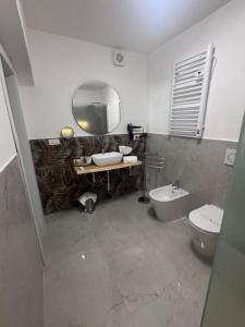 a bathroom with a sink and a toilet and a mirror at Romantic Suite Genova in Genoa +10 photos
