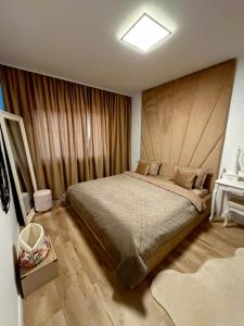 a bedroom with a large bed with a wooden headboard at L&D Apartments in Urseni