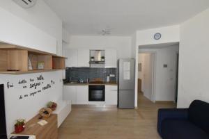 a living room with a kitchen with a refrigerator at Casa Lorica in Pieve Ligure +43 photos