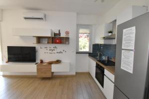 a kitchen with a television and a table in a room at Casa Lorica in Pieve Ligure