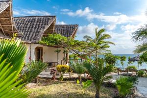 a house on the beach with the ocean in the background at Tunu Beach Zanzibar in Kizimkazi