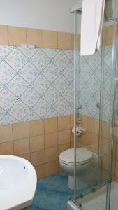a bathroom with a toilet and a sink at Hotel Tre Lanterne in Marina di Sibari +27 photos