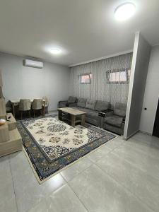 a living room with a couch and a table and a rug at Ashtarak home in Ashtarak +1 photo