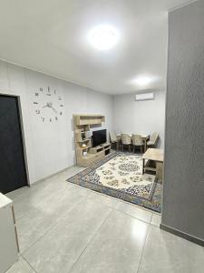 a living room with a television and a table and chairs at Ashtarak home in Ashtarak