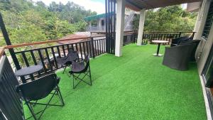 a balcony with green artificial grass on a house at Casa Domingo Guest House in Camalig +4 photos