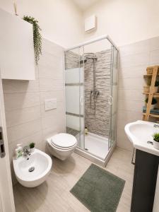 a bathroom with a shower and a toilet and a sink at Piazza Sant'Alfonso Apartment in Francavilla al Mare