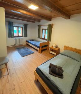 a bedroom with a bed and two beds in it at Apartmán na statku in Teplice