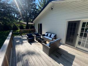 a patio with couches and chairs on a deck at The Borderland in Michigan City