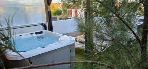 a jacuzzi tub in a yard with trees at Bella Vista 234 in Lajita