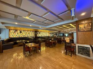 a restaurant with tables and chairs and a bar at Grand Mongolia in Rawalpindi +146 photos