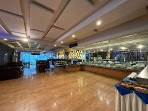 a banquet hall with a dance floor and a bar at Grand Mongolia in Rawalpindi