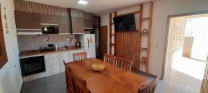 a kitchen with a wooden table and a dining room at Complejo Cerro Morado in Villa Unión