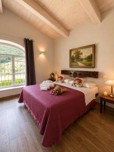 a bedroom with two beds and a large window at Dimora Gubbiano in Cascia
