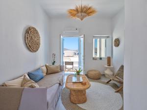 a living room with a couch and a table at Eugene Sea Side Suite in Naousa +30 photos