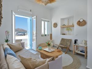 a living room with a couch and a table at Eugene Sea Side Suite in Naousa