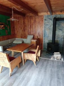 a room with a table and a wood stove at Srub v lese in Hrabŭvka