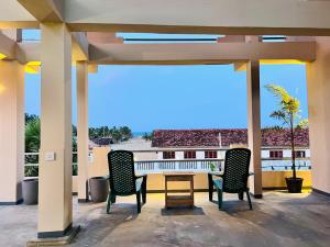 two chairs and a table on a patio with a view at Luna Mara in Arugam Bay +27 photos