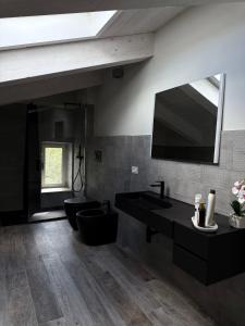a bathroom with a black sink and a mirror at Dimora Gubbiano in Cascia +11 photos