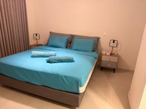 a bed with two pillows on it in a room at Apartment Odysea in Platanias