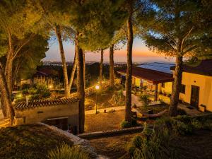 a view of a house with trees at night at Etna Country Home in Nicolosi