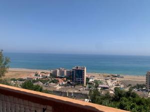 a view of a city and the ocean at Chez NAIM in Tichi