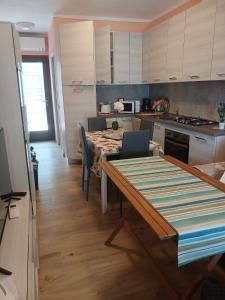 a kitchen with a table and chairs and a kitchen with white cabinets at Dolce Luna in Gargnano +27 photos
