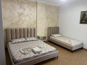 a bedroom with two beds in a room at Amras house in Durrës +26 photos