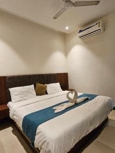 a bedroom with a bed with a stuffed animal on it at Hotel maharaja in Udaipur